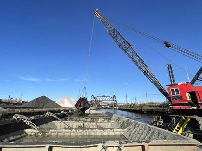 A dredging vessel fills a barge with material pulled from the bottom of the Cuyahoga River, Cleveland, Ohio, Nov. 15, 2023. (Photo: Dave Bala / U.S. Army)