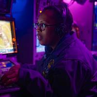 An operations specialist stands watch at the anti-air warfare coordinator console in the combat information center aboard the Arleigh Burke-class guided-missile destroyer USS Gravely. Source: US Navy Petty Officer 1st Class Jonathan Word