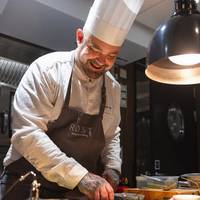 Head Chef Douglas Spiik preparing food for Hurtigruten's guests onboard MS Trollfjord's fine dining restaurant Røst courtesy of Hurtigruten