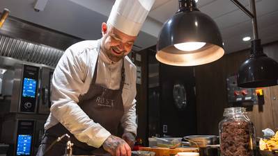 Head Chef Douglas Spiik preparing food for Hurtigruten's guests onboard MS Trollfjord's fine dining restaurant Røst courtesy of Hurtigruten